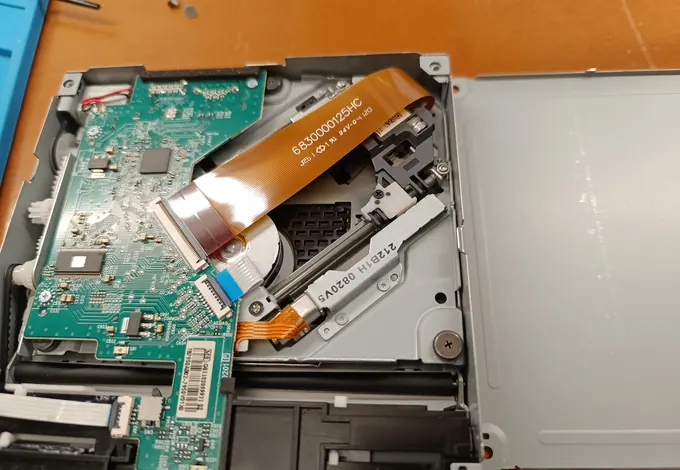 Xbox Series X aperta con il gruppo lettore visibile durante una lavorazione.